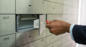 Hand turns the key that opens the safe deposit box