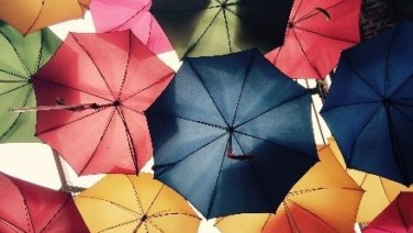 Looking up at colored umbrellas