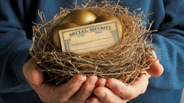Man Holding Nest With Golden Eggs And Social Security Card