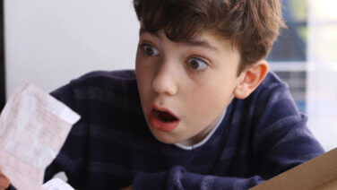 young teenage boy shocked by pizza bill